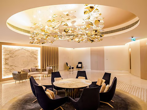 Luxury lobby interior at The Meydan Hotel with gold chandelier and premium furnishings